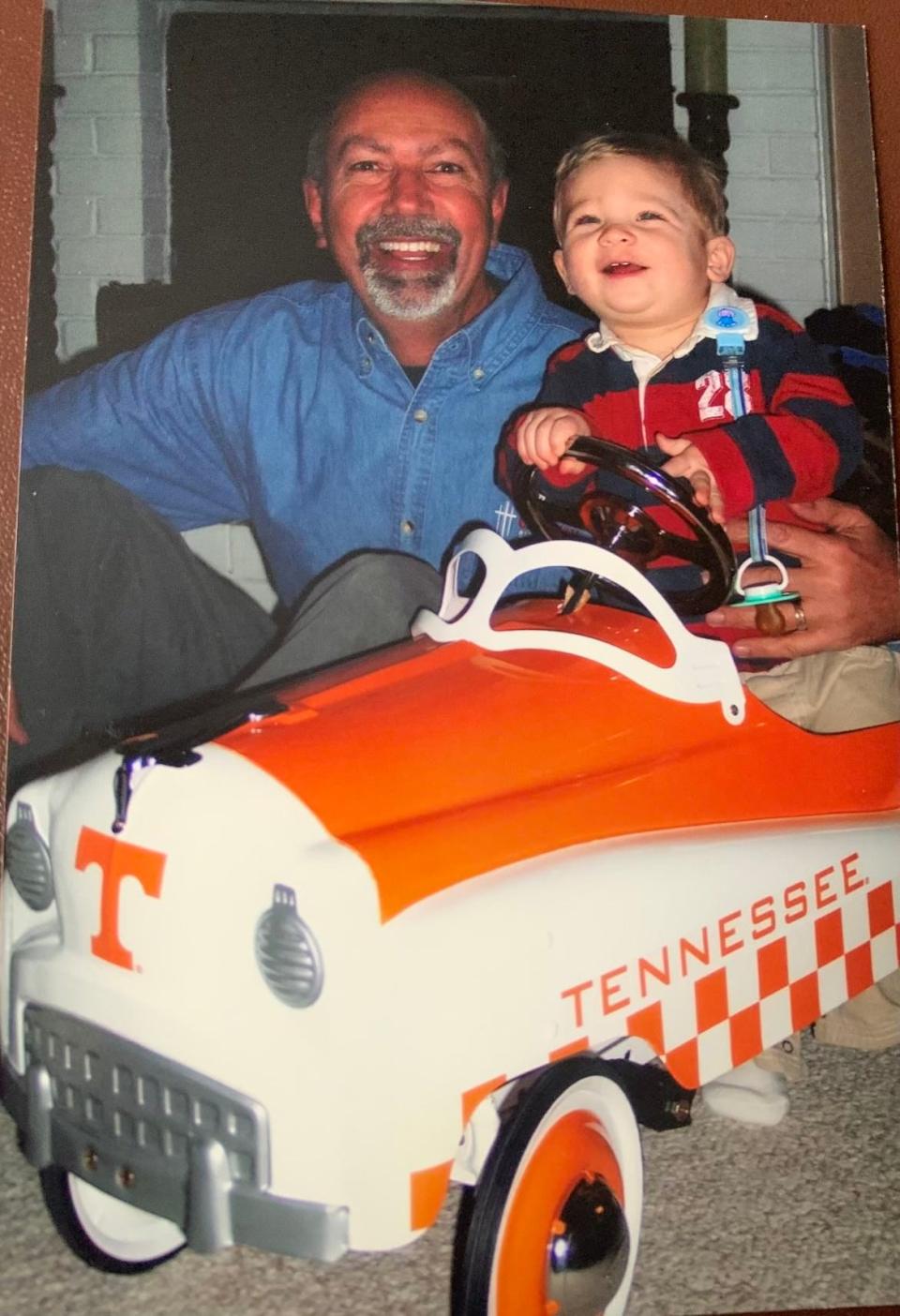 A young Eli Austin, right, with his grandfather, Dr. Tony Long. Long took Austin to his first Tennessee game when he was 2 years old, and a fandom was born.