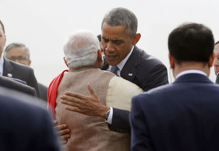 U.S. President Barack Obama hugs Prime Minister Narendra Modi as he arrives at Air Force Station Palam in New Delhi January 25, 2015. REUTERS/Jim Bourg