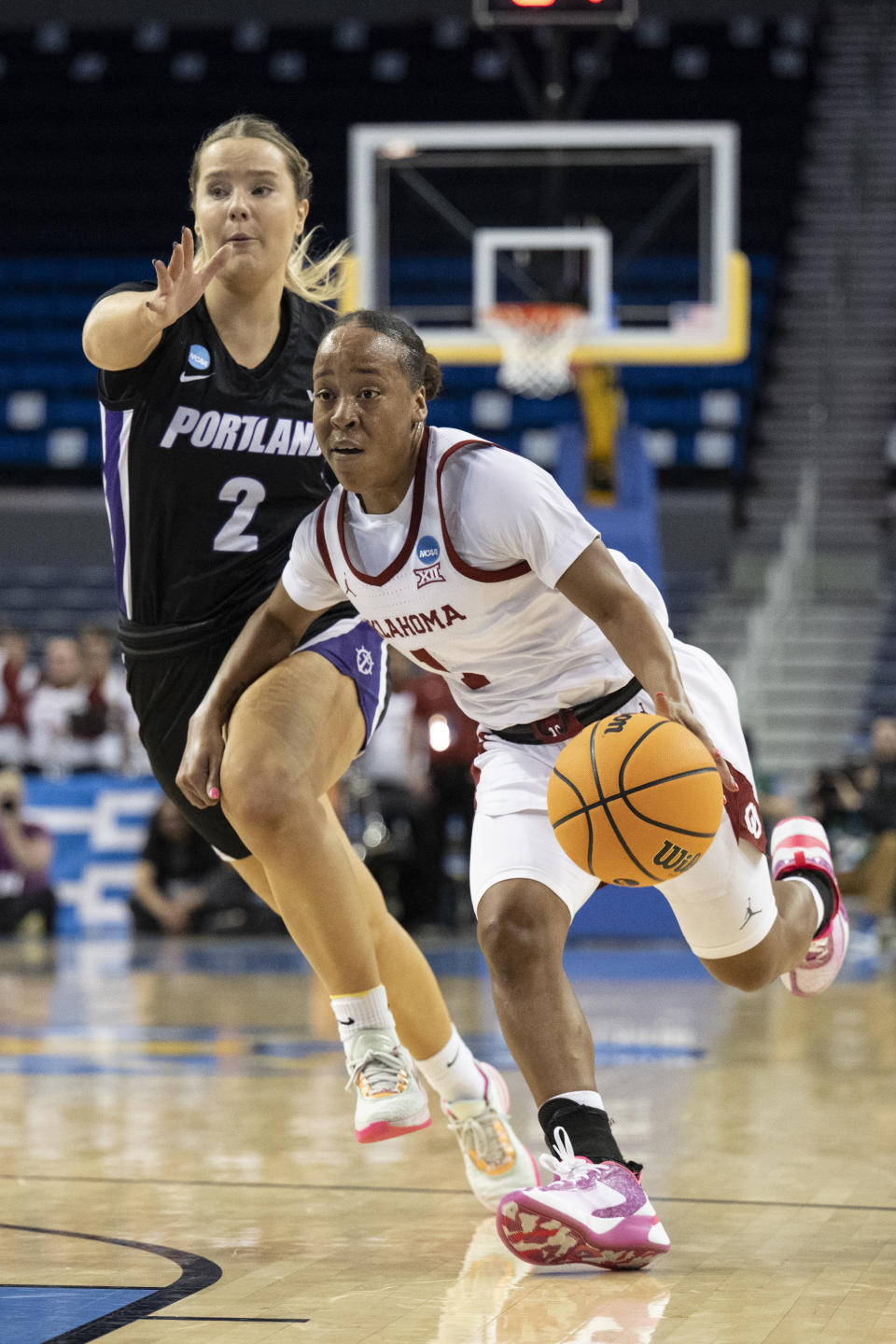 Portland guard McKelle Meek (1) drives toward the basket past Portland forward Keeley Frawley (2) during the first half of a first-round college basketball game in the women's NCAA Tournament, Saturday, March 18, 2023, in Los Angeles. (AP Photo/Kyusung Gong)
