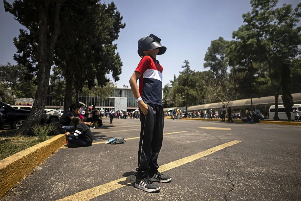  A boy looks through a welders mask at the total eclipse in Mexico City. (Carl de Souza / AFP via Getty Images)