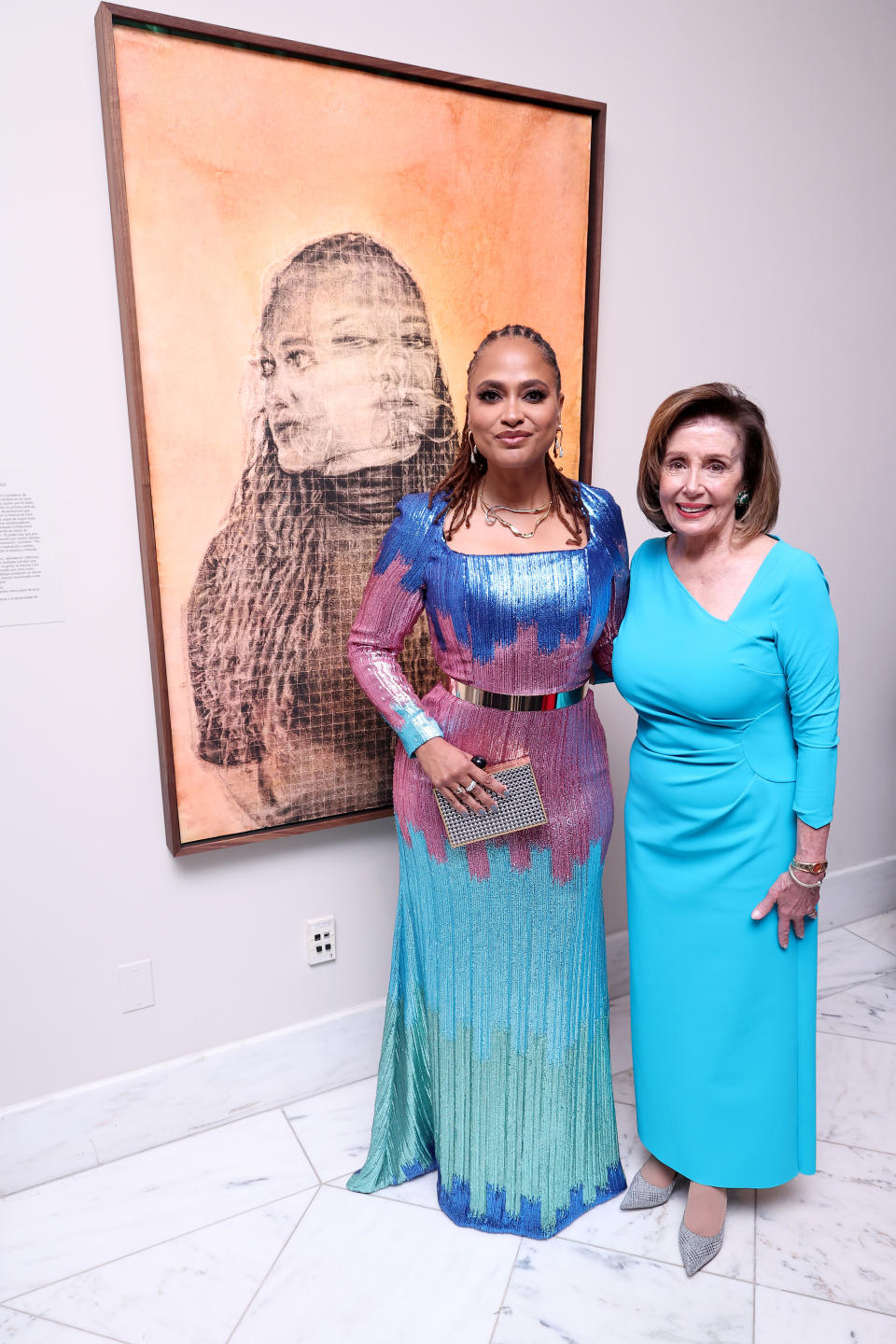 Ava DuVernay and Nancy Pelosi in front of DuVernay’s portrait at the 2022 Portrait Of A Nation Gala.