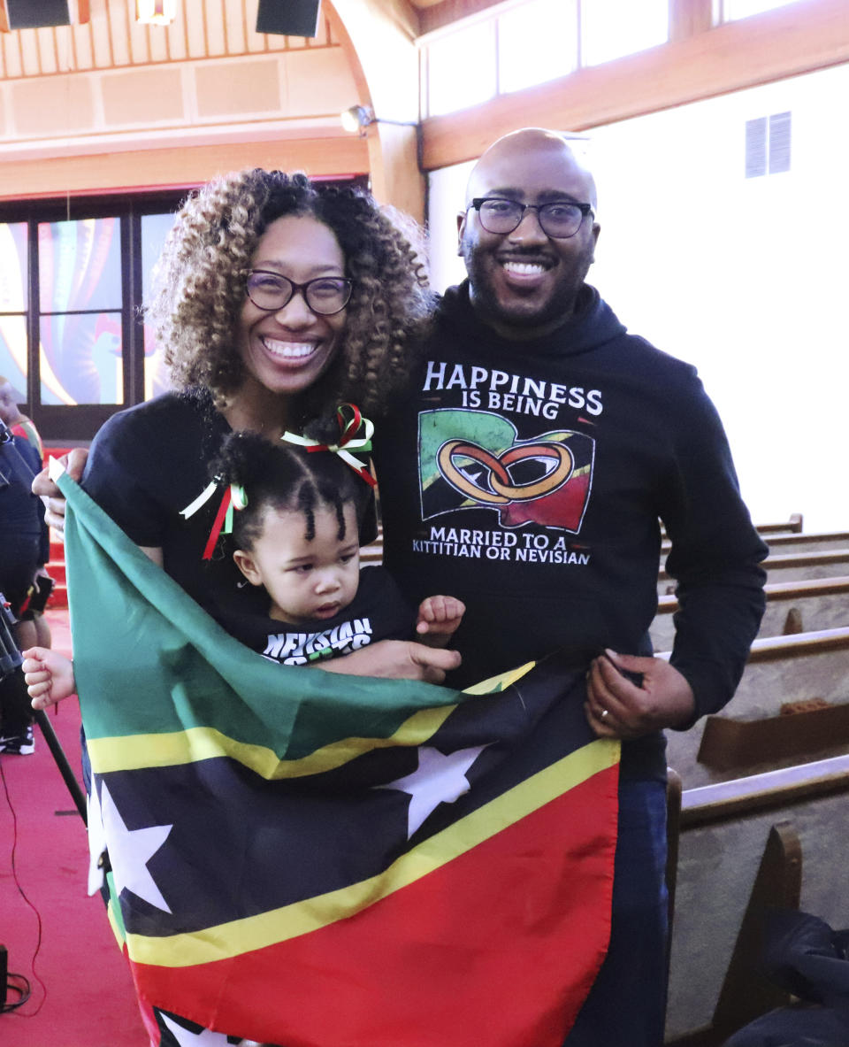 Brian and Janelle White and their daughter, Eliana, pose for a photo after the "Caribbean Sabbath" at Metropolitan Seventh-day Adventist Church in Hyattsville, Md., on Saturday, Feb. 18, 2023. Janelle is from Nevis, part of St. Kitts and Nevis. (Adelle M. Banks/RNS via AP)