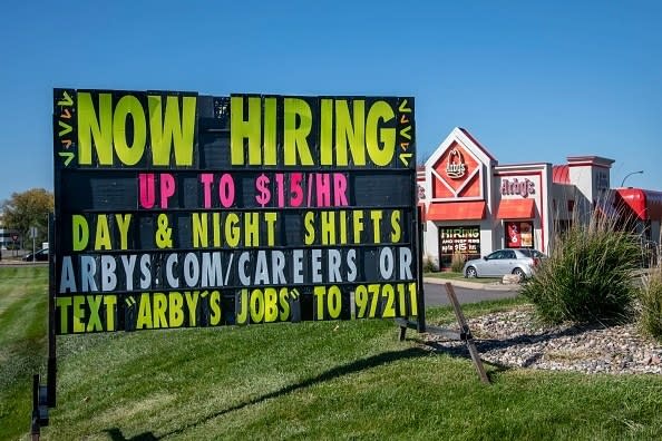 A now hiring sign outside of an arby's
