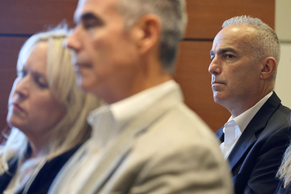 Andrew Pollack, right, and Gena and Tom Hoyer attend a hearing at the Broward County Courthouse in Fort Lauderdale, Fla., Monday, Dec. 18, 2023. Hoyer's son, Luke, and Pollack's daughter, Meadow, were killed in the 2018 shootings at Marjory Stoneman Douglas High School. (Amy Beth Bennett/South Florida Sun-Sentinel via AP, Pool)