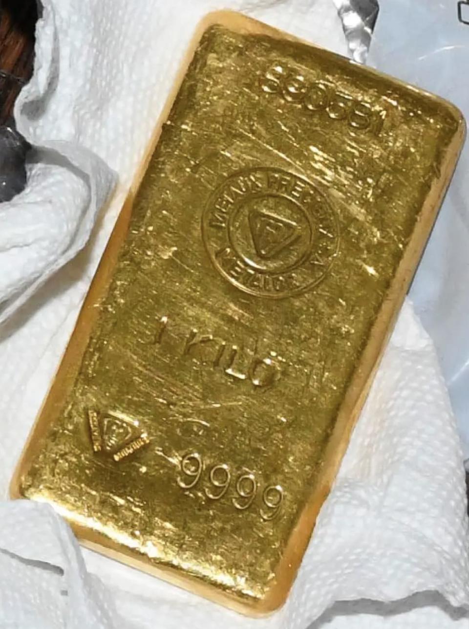 A gold bar on a white sheet