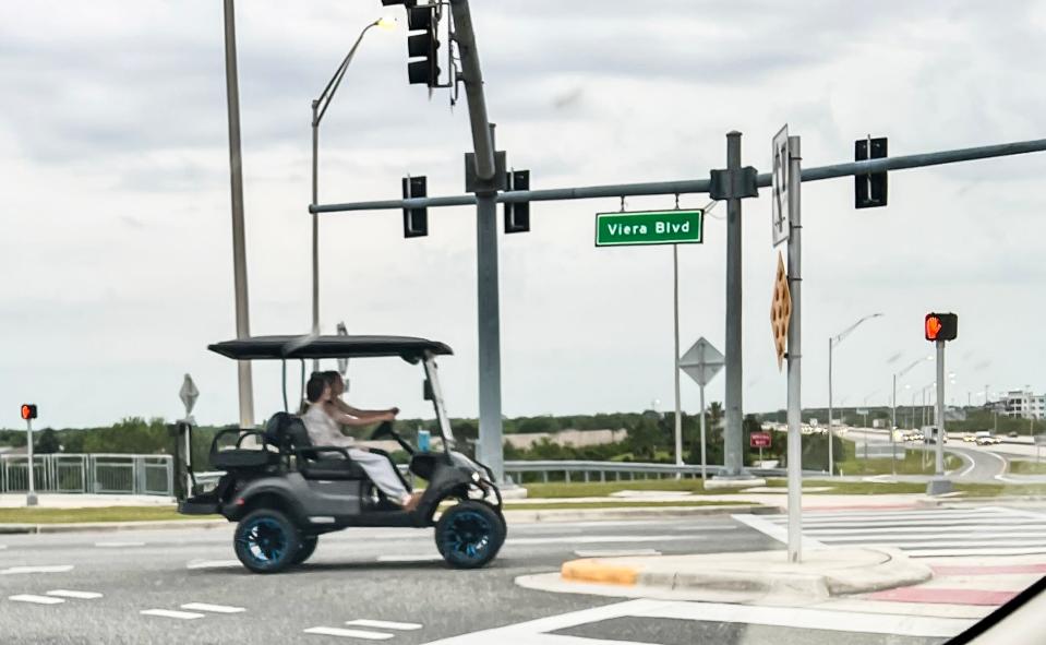 A golf cart drives through the diverging diamond interchange at Viera Blvd. and I-95 Wednesday, March 27, 2024. Craig Bailey/FLORIDA TODAY via USA TODAY NETWORK