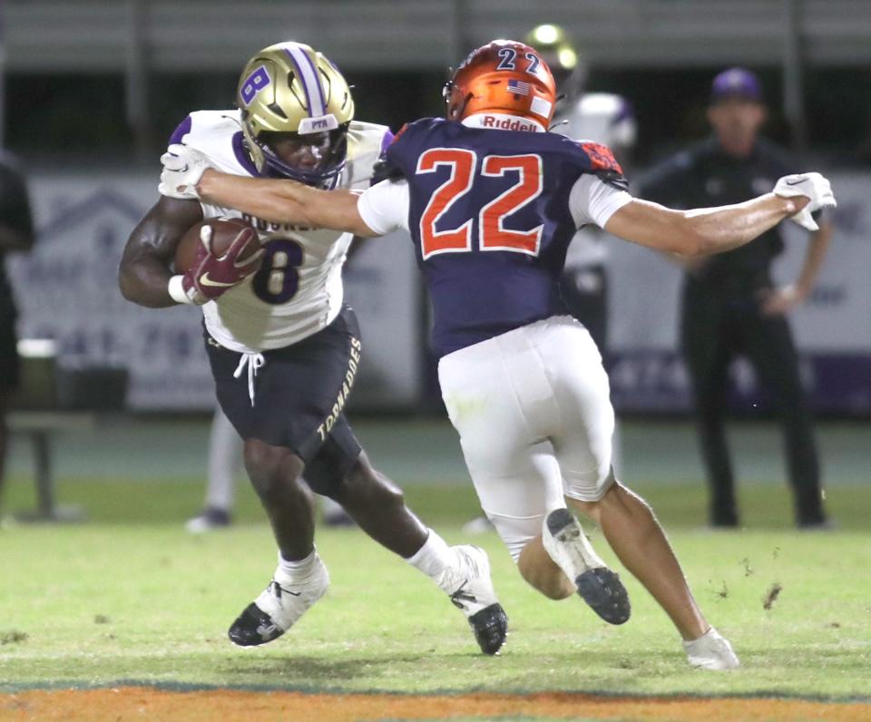 Booker running back Ahmad Hunter (8) is pursued by Lemon Bay linebacker Caleb Hutcherson (22) during Friday night football action at Lemon Bay High School. MATT HOUSTON/HERALD-TRIBUNE