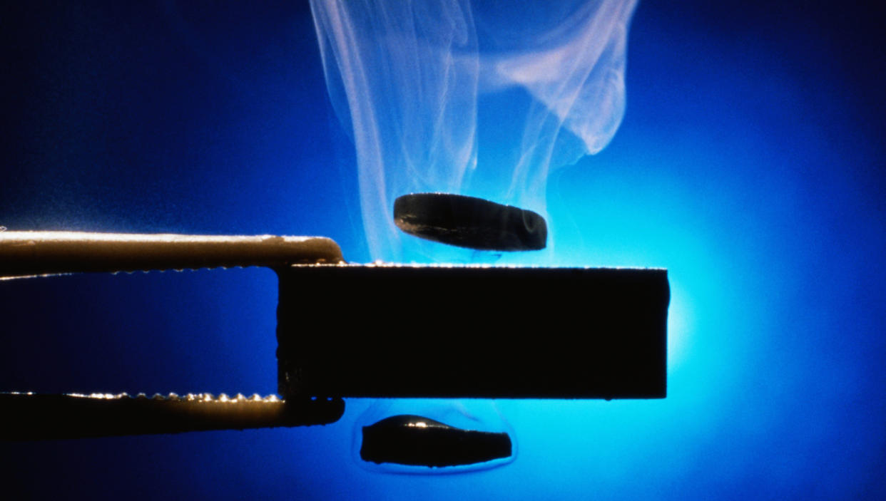  Supercooled superconductor samples float above and beneath a magnet. 