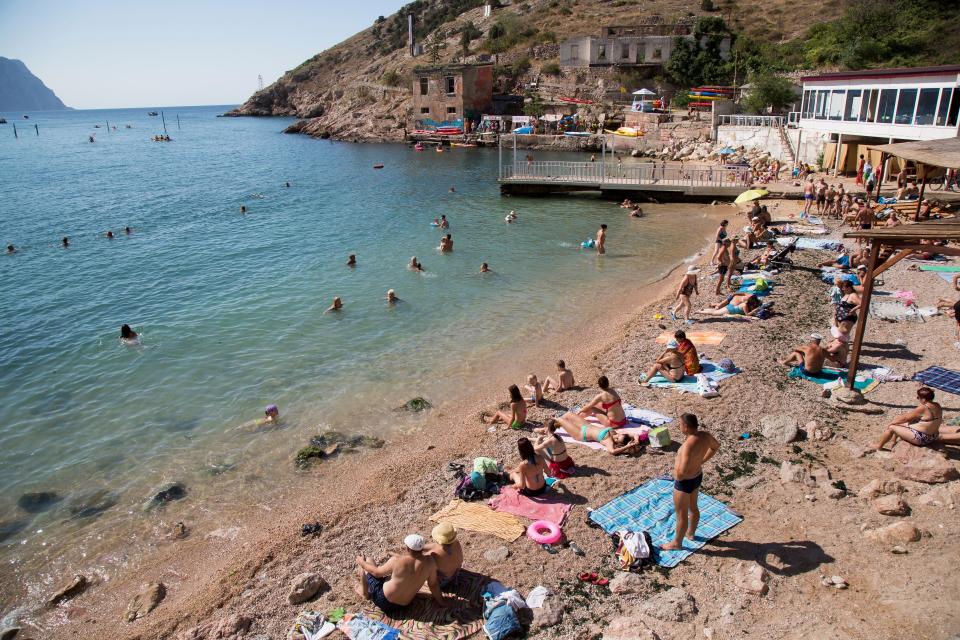 People gather at the beach area of the Black Sea, in Balaklava's bay, a part of Sevastopol on the Crimean Peninsula (AP)