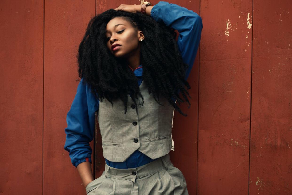 black-woman-wearing-gray-waist-coat-and-blue-long-sleeved-shirt