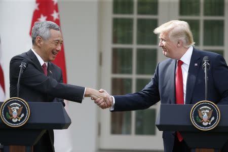 Singapore's Prime Minister Lee Hsien Loong and U.S. President Donald Trump give joint statements in the Rose Garden of the White House in Washington, U.S., October 23, 2017. REUTERS/Joshua Roberts