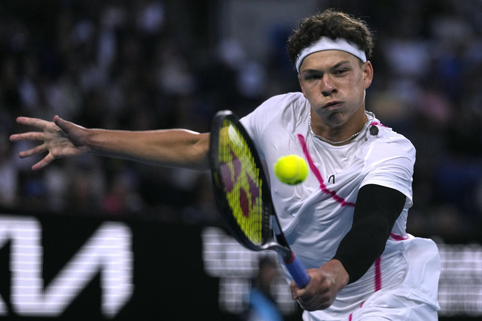 Ben Shelton of the U.S. plays a backhand return to Adrian Mannarino of France during their third round match at the Australian Open tennis championships at Melbourne Park, Melbourne, Australia, Friday, Jan. 19, 2024. (AP Photo/Louise Delmotte)