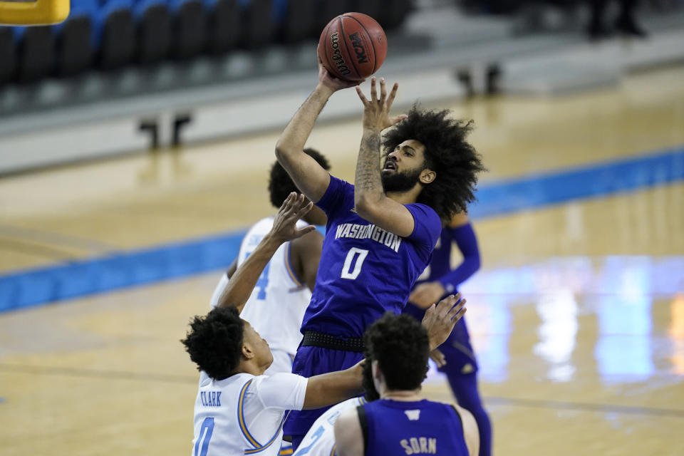 Washington guard Marcus Tsohonis (0) takes a shot against UCLA guard Jaylen Clark (0) during the first half of an NCAA college basketball game Saturday, Jan. 16, 2021, in Los Angeles. (AP Photo/Ashley Landis)