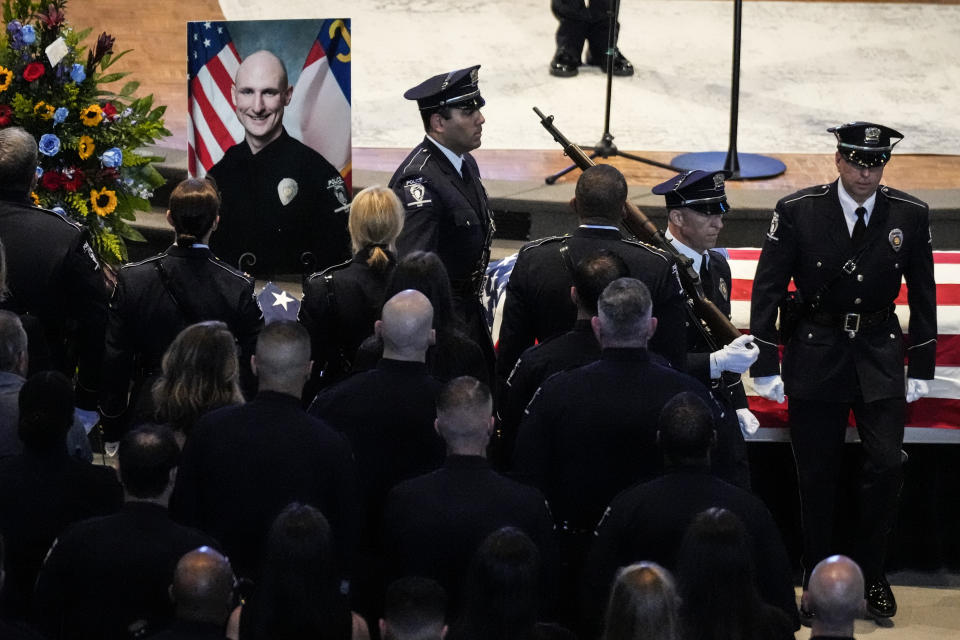 An honor guard assembles during a memorial service for Officer Joshua Eyer, Friday, May 3, 2024, in Charlotte, N.C. Police in North Carolina say a shootout that killed Eyer and wounded and killed other officers began as officers approached a home to serve a felony warrant on Monday. (AP Photo/Chris Carlson)