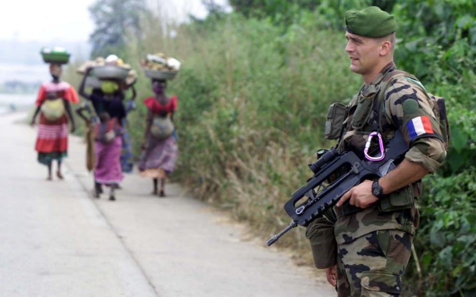 A newly arrived member of the 1st Company of the 2nd Regiment of French Foreign Legion Paratroopers stands at a checkpoint on the Sassandra river near Guessabo, Ivory Coast, in 2002.  - CHRISTINE NESBITT /AP