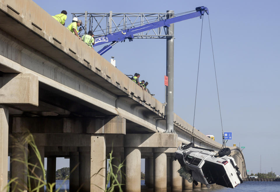 A vehicle is lifted out of Lake Maurepas under Interstate-55 near Manchac, Tuesday, October 24, 2023. Authorities say at least seven people were killed Monday after a “superfog” of smoke from south Louisiana marsh fires and dense fog caused multiple massive car crashes involving 158 vehicles. (Brett Duke/The Times-Picayune/The New Orleans Advocate via AP)