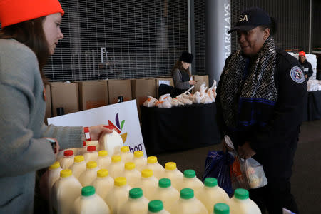 A Transportation Security Administration (TSA) employee receives a donation at a food distribution center for federal workers impacted by the government shutdown, at the Barclays Center in the Brooklyn borough of New York, U.S., January 22, 2019. REUTERS/Brendan McDermid