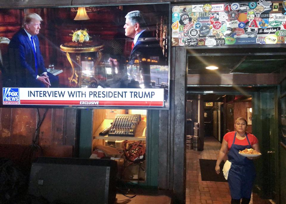 President Donald Trumps pre-game Super Bowl interview with Fox News host Sean Hannity is broadcast in a bar on February 2, 2020 in Washington, D.C.