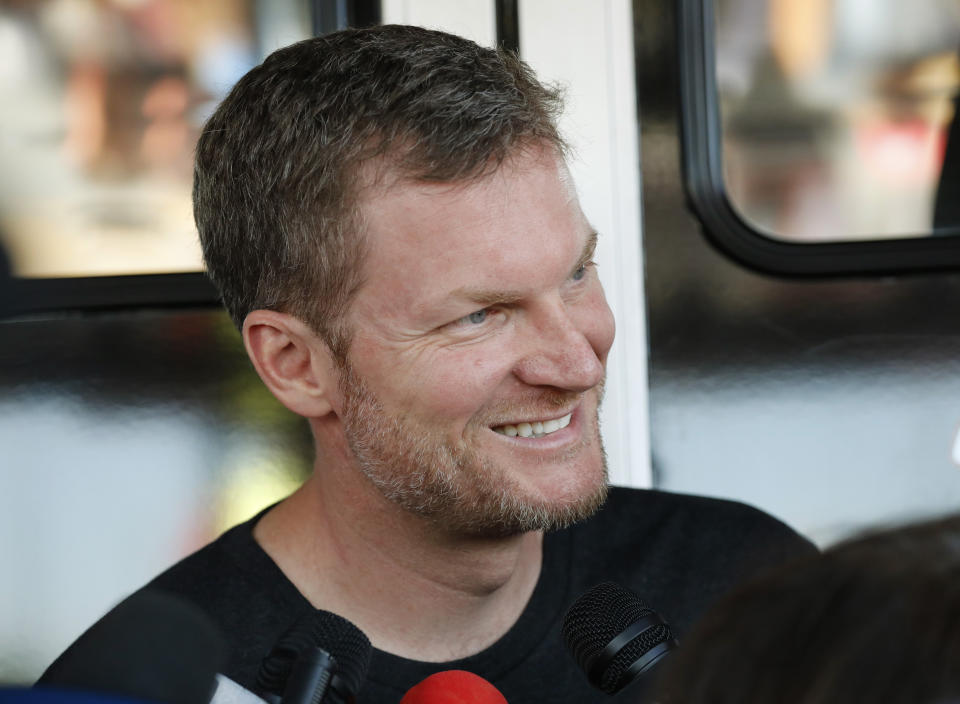 FILE - Dale Earnhardt Jr. talks with the media in the garage area before practice for a NASCAR auto race in Darlington, S.C., in this Friday, Aug. 30, 2019, file photo. He’s a 46-year-old married father of two daughters, a NASCAR Hall of Fame inductee and the 15-time fan-voted most popular driver. No matter all his personal bliss, Earnhardt still has social anxieties and was a wreck when NBC Sports launched its NASCAR coverage at Nashville with a heavily-promoted pre-race show that featured him alongside country star Brad Paisley. “I was terrified,” Earnhardt told The Associated Press of the assignment. (AP Photo/Terry Renna, File)