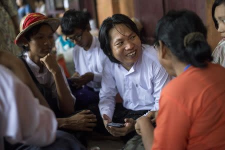 Student activist Nanda Sit Aung talks to his family and friends during a lunch break at a mass trial of the student protesters at Tharrawaddy court, Tharrawaddy, Bago, August 25, 2015. REUTERS/Minzayar