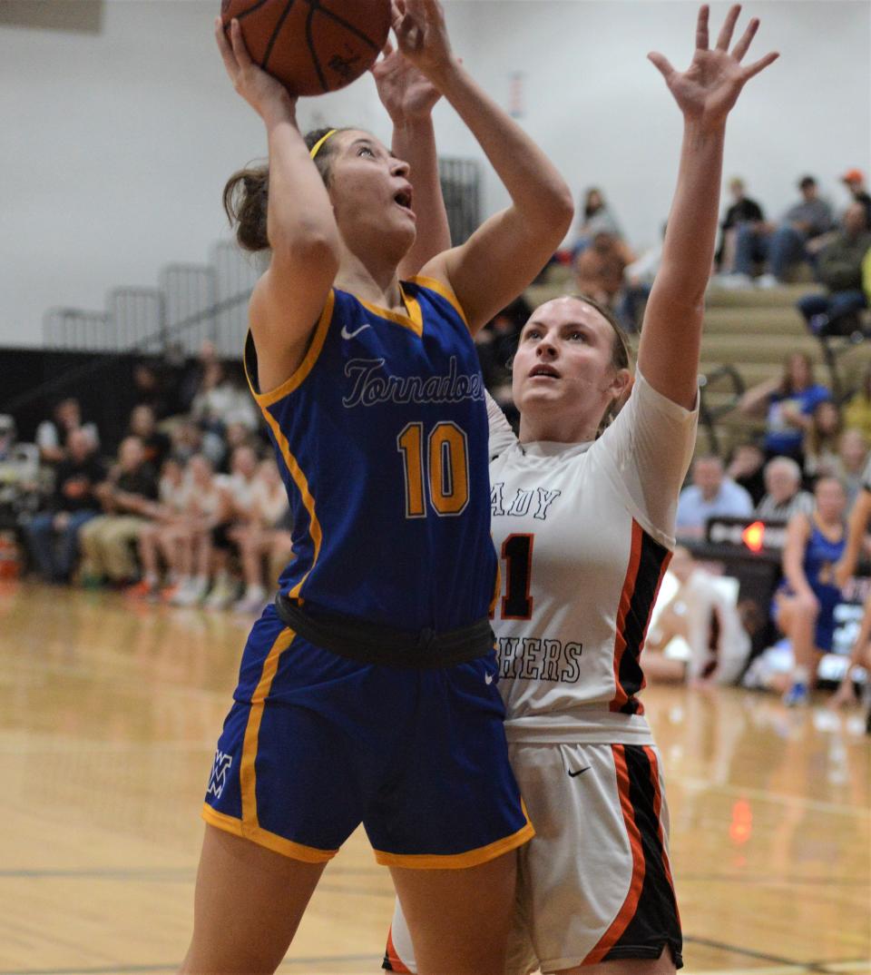 West Muskingum's Caitlyn Drake goes up for a shot in the fourth quarter against New Lexington's Kim Kellogg in the MVL Small School Division clash. Drake was named All-Ohio Honorable Mention in Division III.
