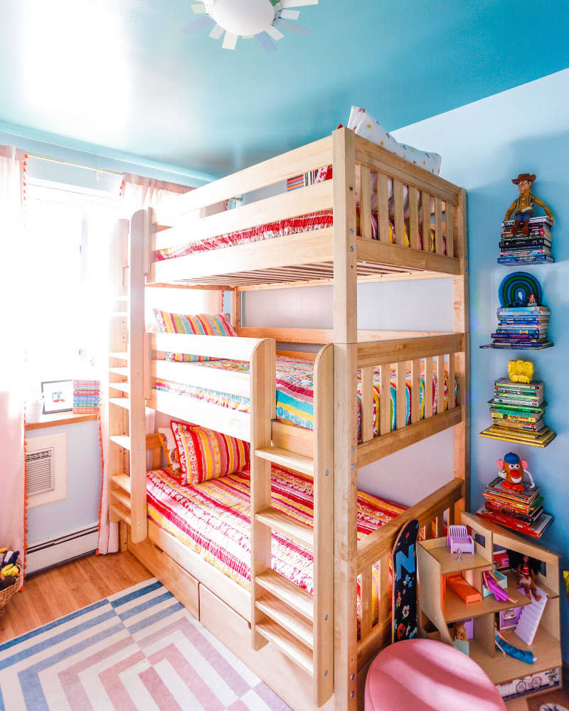 Blue kids bedroom with wood bunk beds and colorful accents