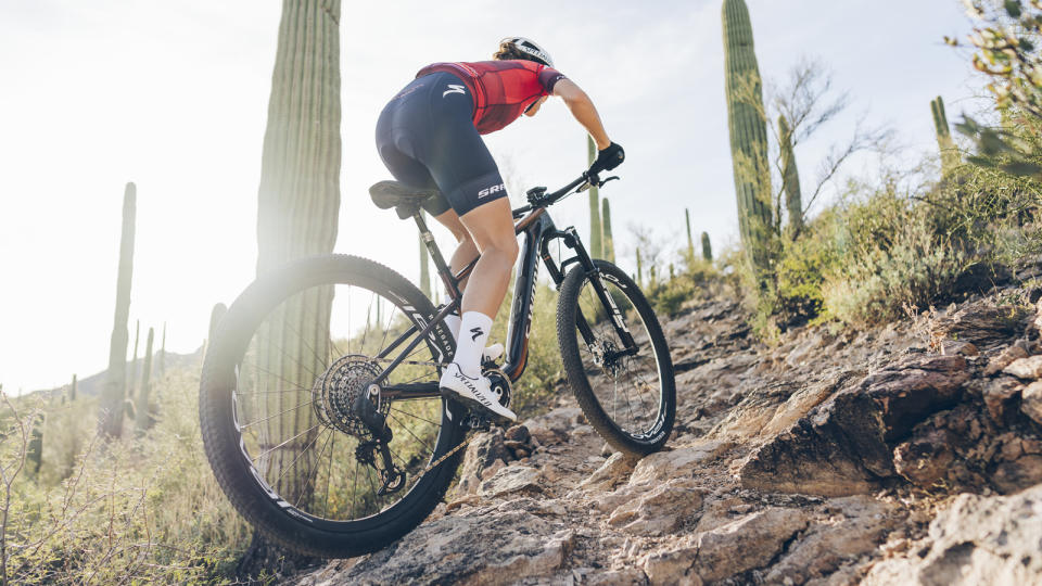 A mountain biker climbing up a rocky climb