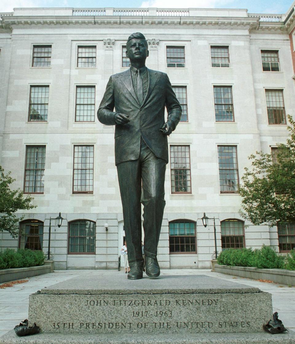 FILE - In this Sept. 12, 2000 file photo, a memorial statue of President John F. Kennedy stands on the grounds of the Massachusetts Statehouse in Boston. Three cities loom large in the life and death of John F. Kennedy: Washington, D.C., where he served as U.S. president and as a senator; Dallas, where he died, and Boston, where he was born. With the 50th anniversary of his Nov. 22, 1963 assassination at hand, all three places are worth visiting to learn more about him or to honor his legacy. (AP Photo/SEVANS, file)