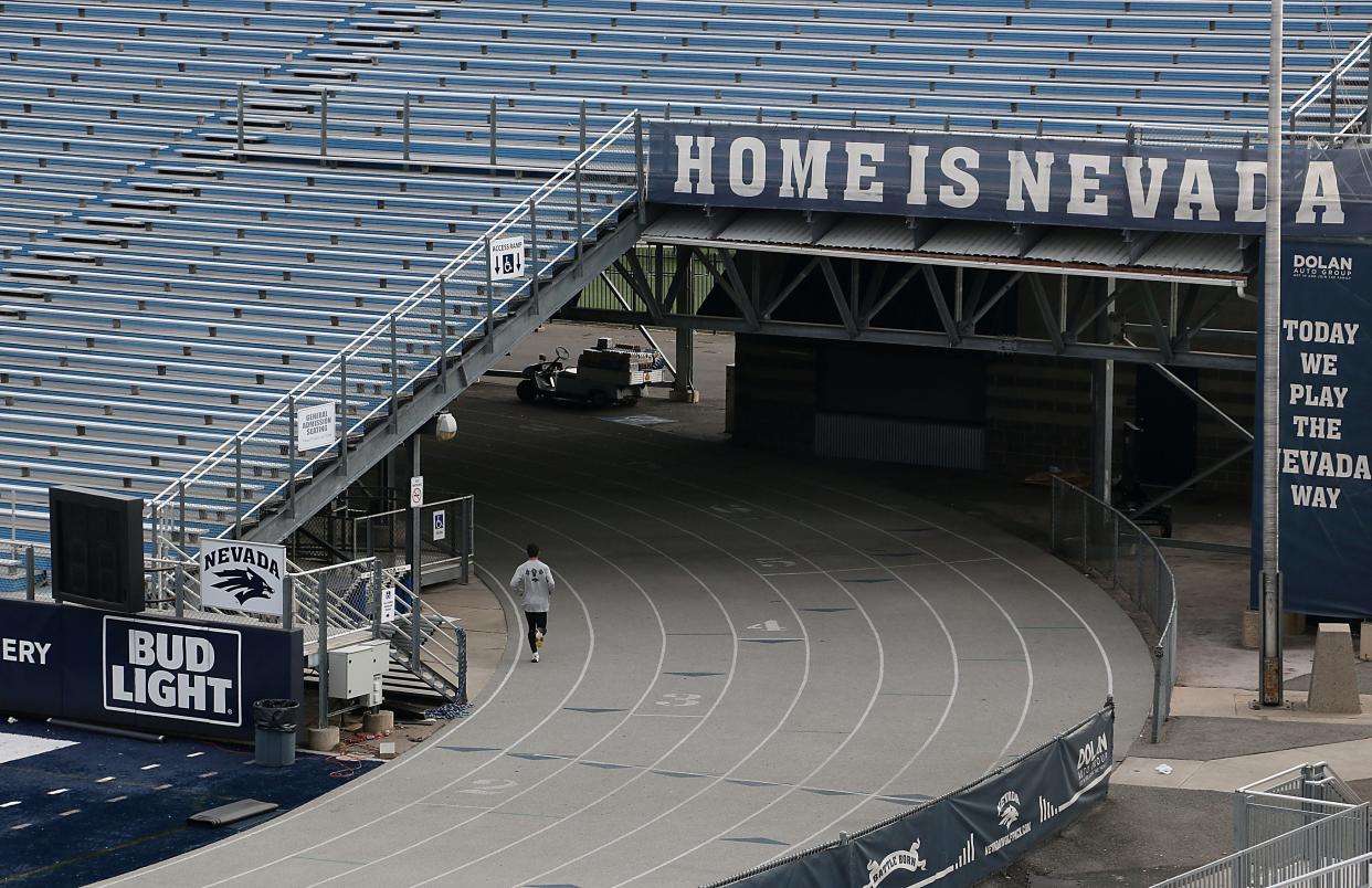 A runner heads into the tunnel under bleachers at Mackay Stadium in December 2023.