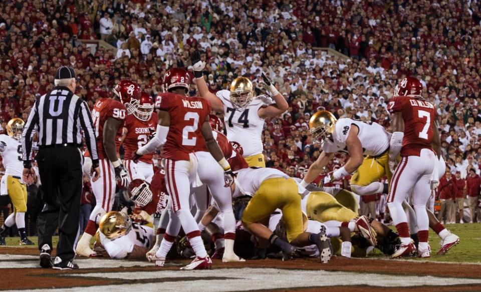 Oct. 27, 2012; Norman, OK, USA; Notre Dame Fighting Irish offensive tackle Christian Lombard (74) signals touchdown after quarterback Everett Golson (5) (not shown) scored in the fourth quarter against the Oklahoma Sooners at Oklahoma Memorial Stadium. Notre Dame won 30-13. Mandatory Credit: Matt Cashore-USA TODAY Sports