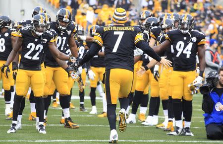 Dec 21, 2014; Pittsburgh, PA, USA; Pittsburgh Steelers quarterback Ben Roethlisberger (7) is greeted by teammates as he takes the field against the Kansas City Chiefs during the first quarter at Heinz Field. Mandatory Credit: Charles LeClaire-USA TODAY Sports