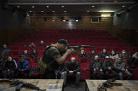 Ukrainian civilians receive weapons training inside a cinema in Lviv, western Ukraine, Saturday, March 5, 2022. (AP Photo/Felipe Dana)