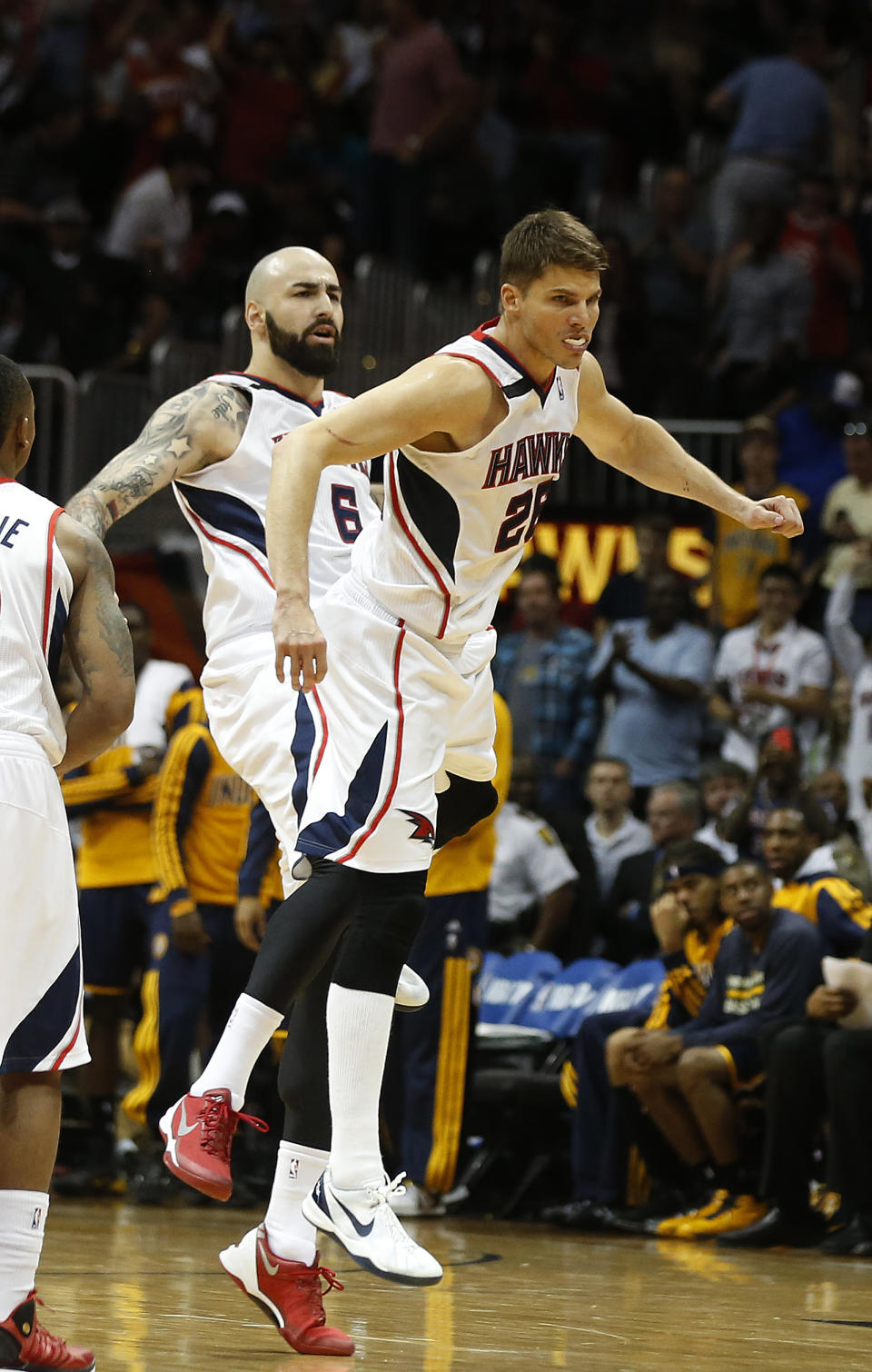 Atlanta Hawks guard Kyle Korver (26) celebrates with center Pero Antic, left, celebrate after hitting a three-point basket in the second half of Game 3 of an NBA basketball first-round playoff series against the Indiana Pacers, Thursday, April 24, 2014, in Atlanta. The Hawks won 98-85. (AP Photo/John Bazemore)