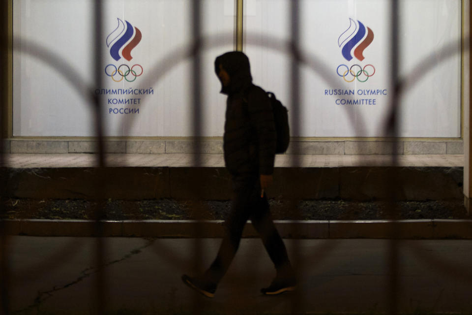 FILE- A man walks by the Russian Olympic Committee building in Moscow, Russia, Monday, Nov. 9, 2015. Russian athletes are competing under the acronym ROC, for Russian Olympic Committee, for the third time. The national colors and flag are banned by the International Olympic Committee because of a massive state-sponsored doping operation during the 2014 Sochi Games, which Russia hosted. (AP Photo/Ivan Sekretarev, File)