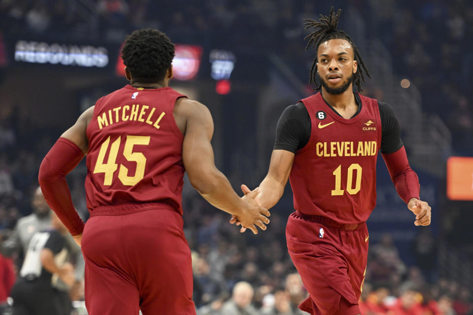 Cleveland Cavaliers guards Donovan Mitchell (45) and Darius Garland (10) celebrate a basket by Garland during the first half of an NBA basketball game against the Atlanta Hawks, Monday, Nov. 21, 2022, in Cleveland. (AP Photo/Nick Cammett)