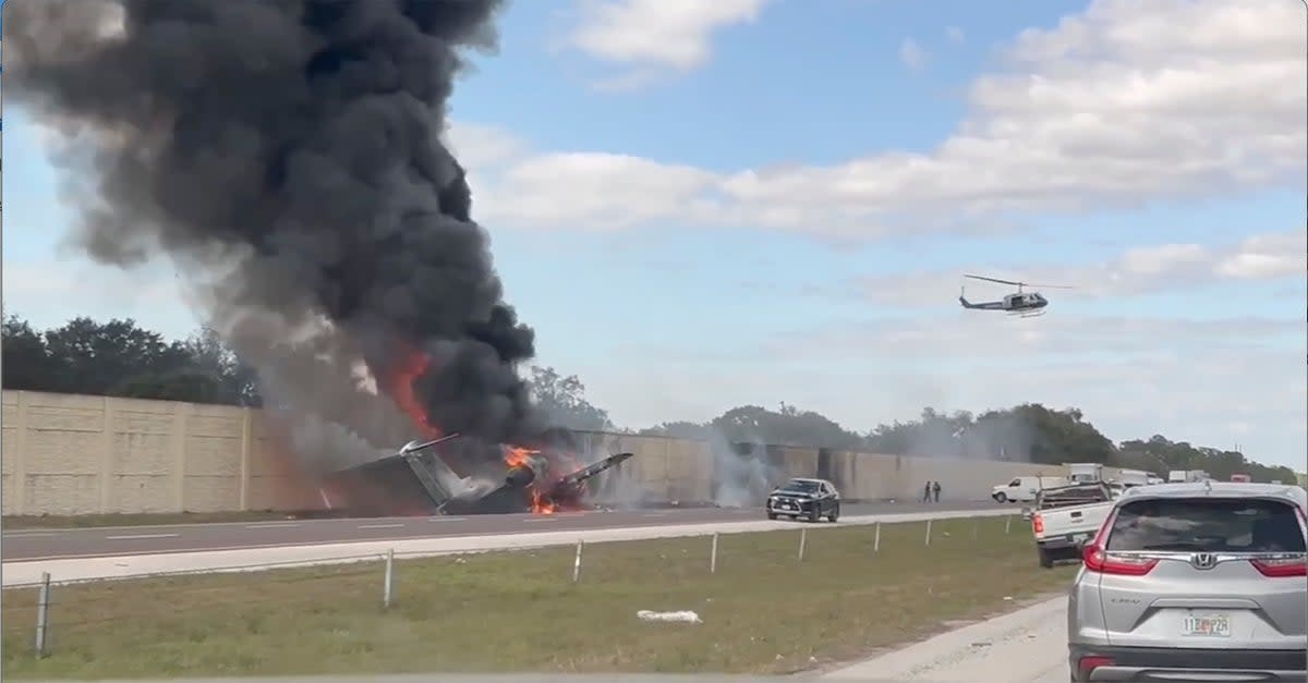 Smoke and fire fills the air after an airplane crashed on Interstate 75 (AP)