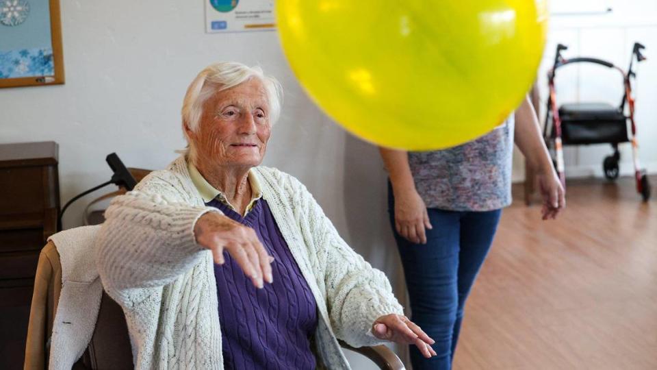 June Gapinski bats a balloon back to others at CAPSLO Adult Day Center in Paso Robles. The center provides adult day care for seniors with Alzheimer’s and other forms of dementia and respite for their family caregivers Jan. 13, 2022.