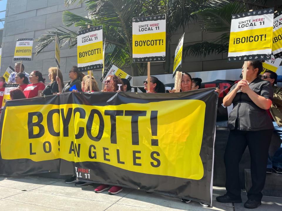Hotel workers hold a banner reading "boycott Los Angeles"