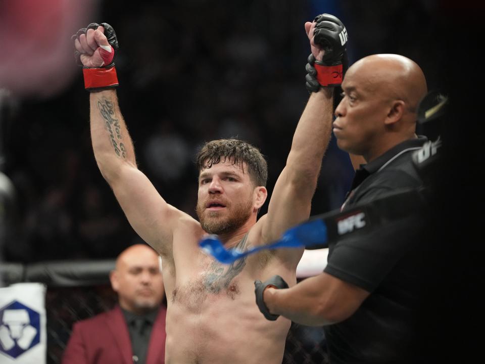 Jul 2, 2022; Las Vegas, Nevada, USA; Jim Miller (red gloves) reacts after defeating Donald Cerrone (blue gloves) in a bout during UFC 276 at T-Mobile Arena. Mandatory Credit: Stephen R. Sylvanie-USA TODAY Sports