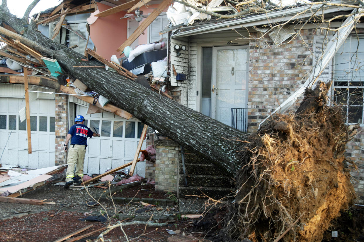 A firefighter checks homes for injured residents in Little Rock, Ark. (Benjamin Krain / Getty Images)