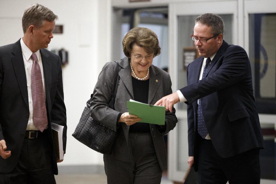 Sen. Dianne Feinstein, D-Calif., chair of the Senate Intelligence Committee, makes her way to the chamber to advance a bill providing $1 billion in loan guarantees to Ukraine as President Barack Obama meets with U.S. allies in Europe to punish Moscow for its annexation of the Crimean peninsula, at the Capitol in Washington, Monday, March 24, 2014. (AP Photo/J. Scott Applewhite)