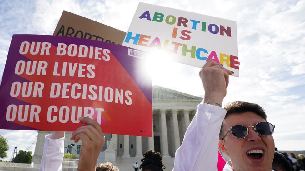 Abortion rights supporters hold placards on the day the Supreme Court justices hear oral arguments over the legality of Idaho's Republican-backed, near-total abortion ban in medical-emergency situations, at the U.S. Supreme Court in Washington, DC