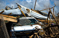 <p>A monkey walks over the rubble left in the wake of Hurricane Maria on Cayo Santiago, known as Monkey Island, in Puerto Rico, one of the worldâs most important sites for research into how primates think, socialize and evolve, on Oct. 4, 2017. The storm destroyed virtually everything on the island, stripping it of vegetation, wrecking the monkeysâ metal drinking troughs and crushing the piers that University of Puerto Rico workers use to bring in bags of monkey chow, brown pellets of processed food that complete the primatesâ natural vegetation diet. (Photo: Ramon Espinosa/AP) </p>