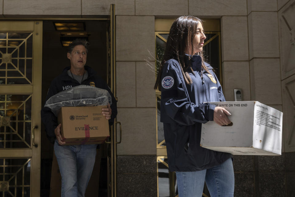 Federal agents carrying evidence boxes walk out of a Park Avenue high-rise on Thursday, Sep. 1, 2022, in New York. FBI agents and Homeland Security Investigations personnel searched properties linked to Viktor Vekselberg, a close ally of Russian President Vladimir Putin. U.S. federal agents on Thursday simultaneously searched properties in Manhattan, the posh beach community of Southampton, N.Y., and on an exclusive Miami island that have been linked to the billionaire Russian oligarch whose $120 million yacht was seized in April. (AP Photo/Yuki Iwamura)