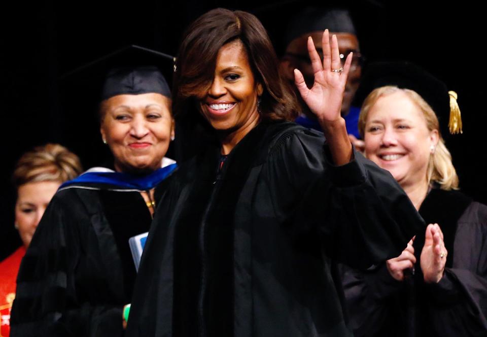 First lady Michelle Obama waves to the crowd before delivering the commencement address to graduates of Dillard University in New Orleans, Saturday, May 10, 2014. (AP Photo/Jonathan Bachman)