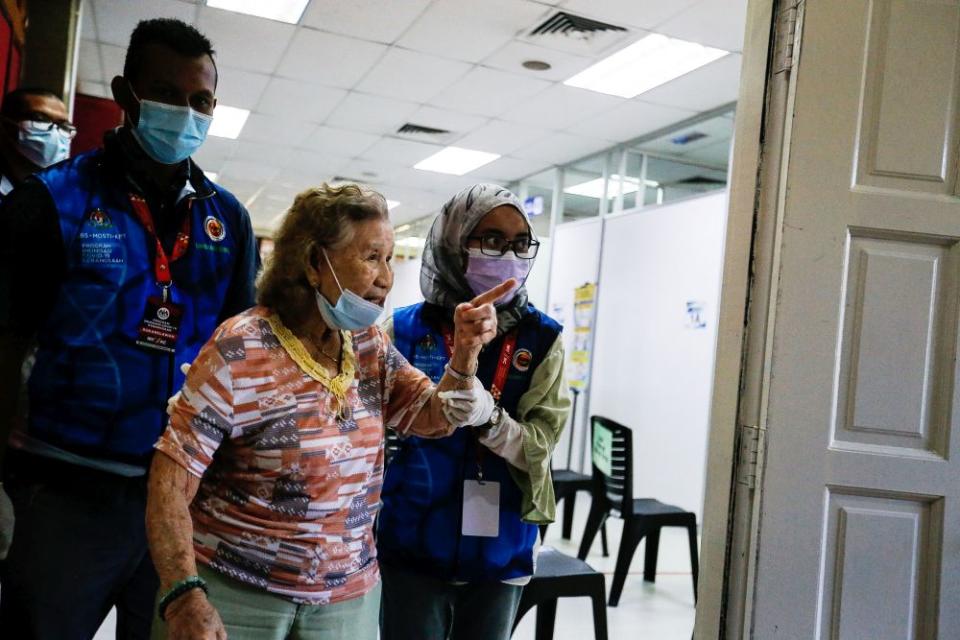 A senior citizen arrives for her Covid-19 shot under phase two of Penang’s immunisation drive at the Caring Society Complex in George Town April 19, 2021. — Picture by Sayuti Zainudin