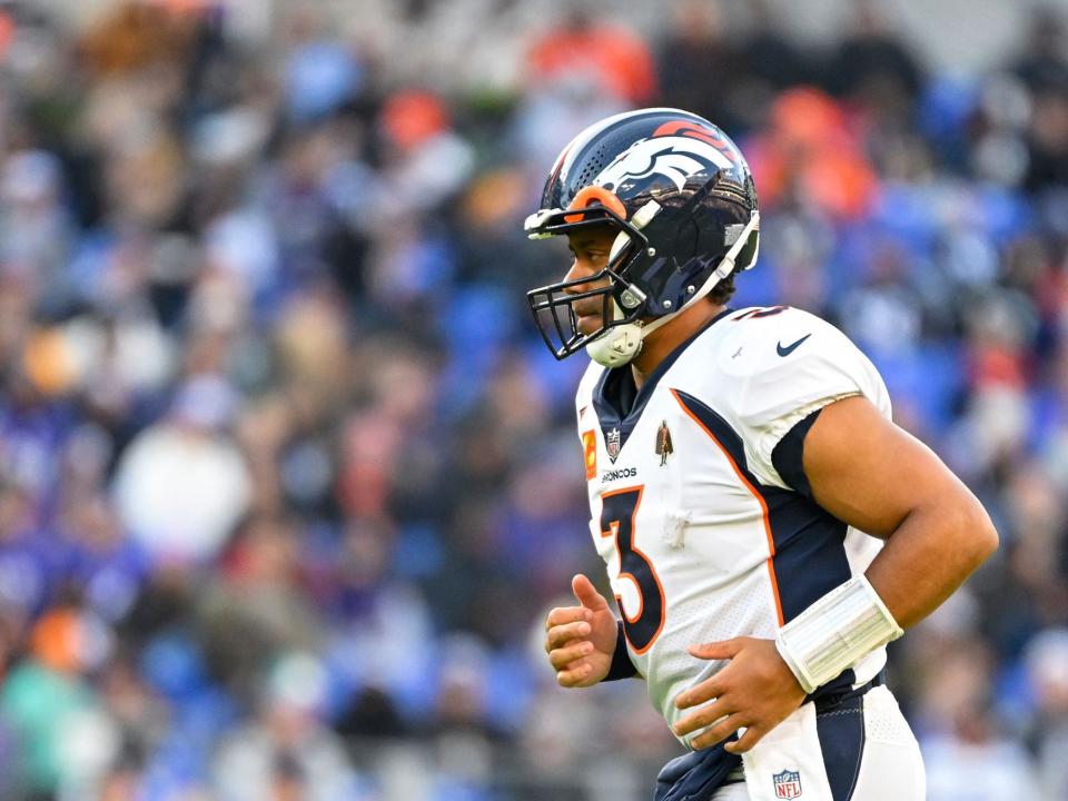 Russell Wilson jogs on the field during a game against the Baltimore Ravens.