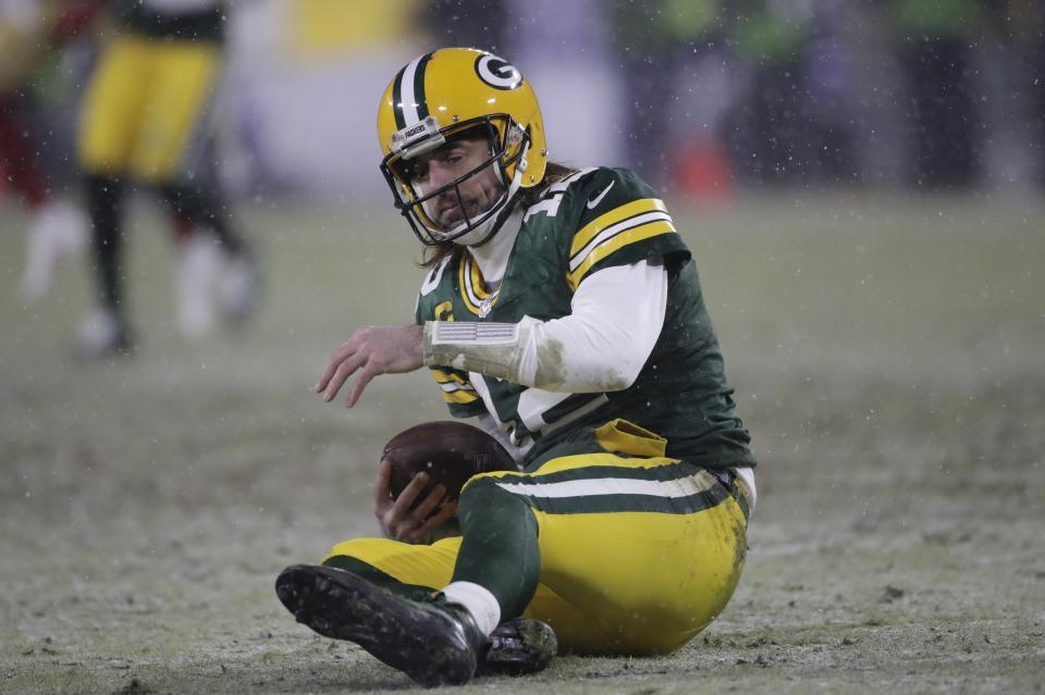 Green Bay Packers' Aaron Rodgers reacts after being sacked by San Francisco 49ers' Arik Armstead during the second half of an NFC divisional playoff NFL football game Saturday, Jan. 22, 2022, in Green Bay, Wis. (AP Photo/Aaron Gash)