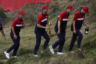 Team USA players head to the clubhouse after the Ryder Cup matches at the Whistling Straits Golf Course Sunday, Sept. 26, 2021, in Sheboygan, Wis. (AP Photo/Charlie Neibergall)