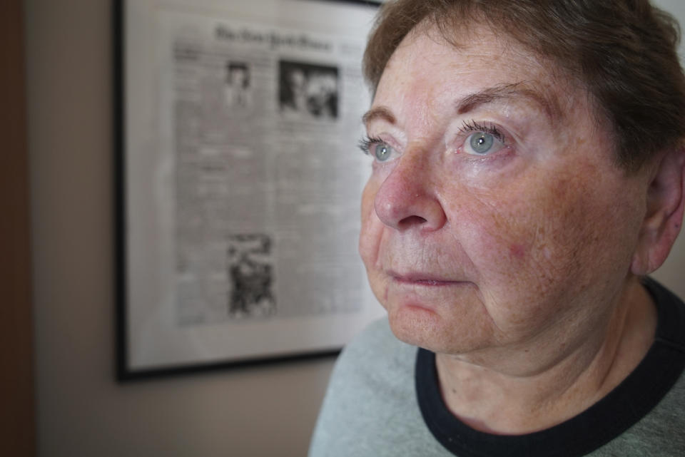 Former Associated Press investigative reporter Jean Heller stands near a copy of her story printed in the front page of The New York Times at her home in Southport, N.C., on Saturday, July 9, 2022. In July 1972, Heller broke the story about the U.S. Public Health Service study in which Black men in Alabama went untreated for syphilis so researchers could document the disease's effects. (AP Photo/Allen G. Breed)